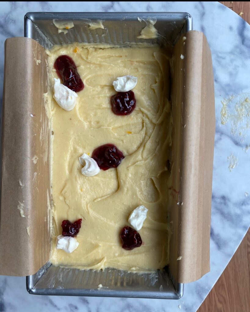 batter in loaf tin with raspberry & cream cheese not swirled