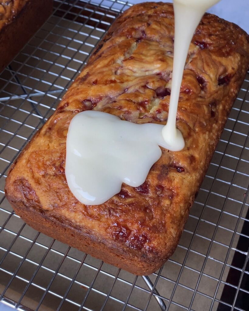baked loaf being glazed