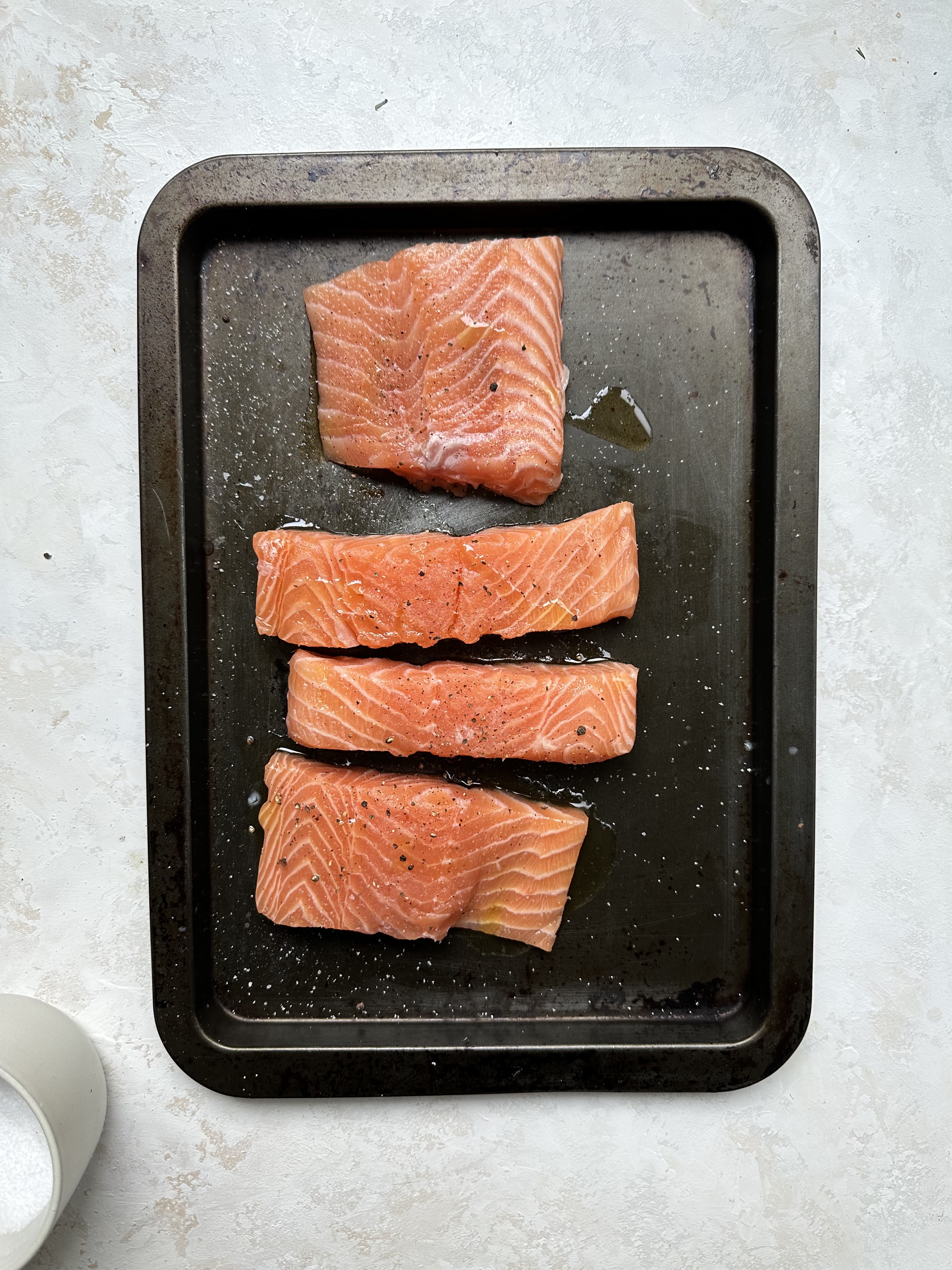 raw salmon seasoned on tray