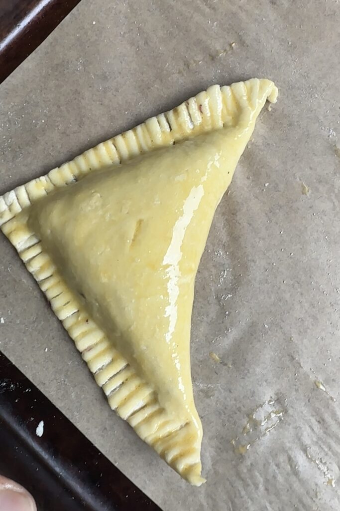 folded & sealed puff pastry turnover with egg wash