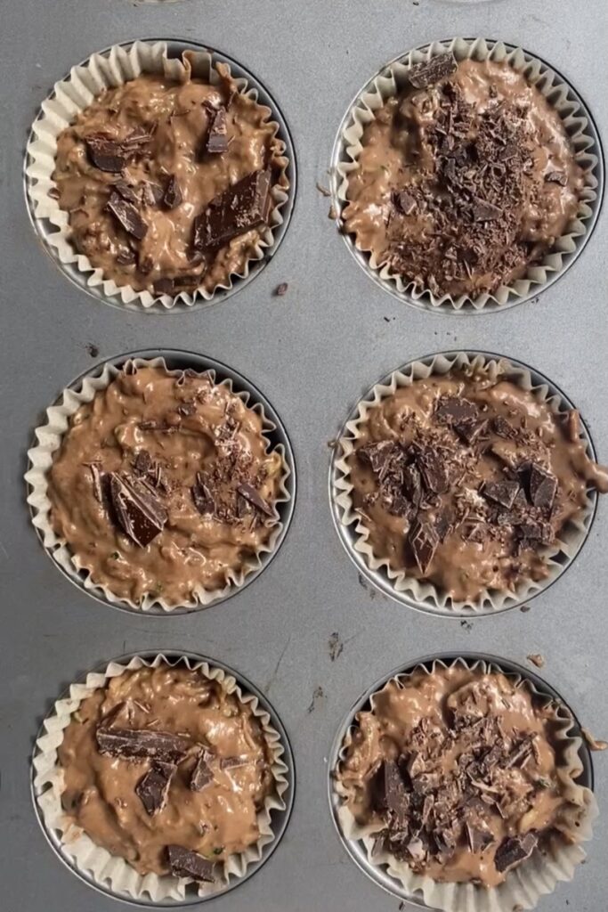 chocolate zucchini muffins in muffin tin